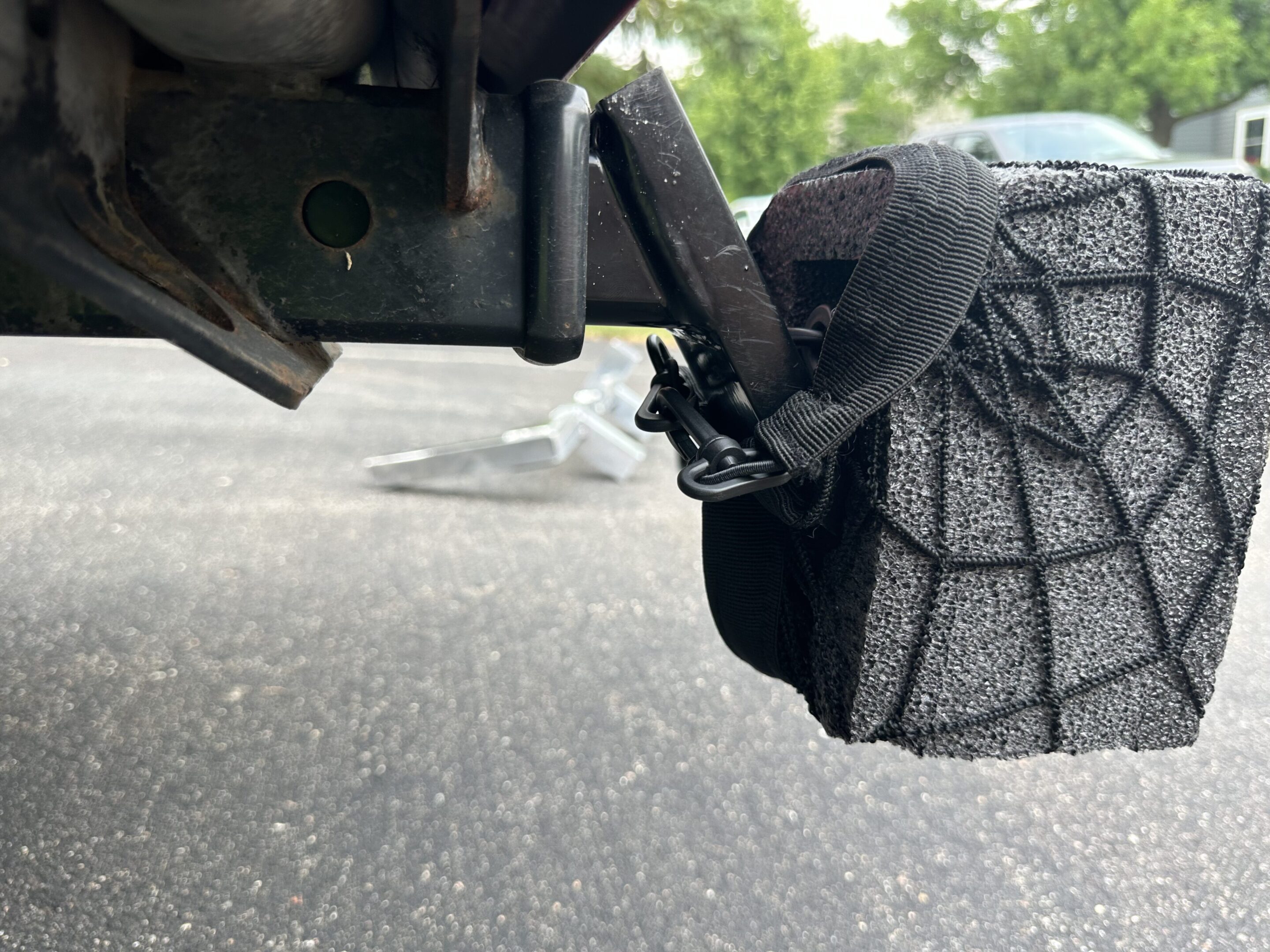 Close-up of a vehicle's hitch pin securing a trailer or accessory.