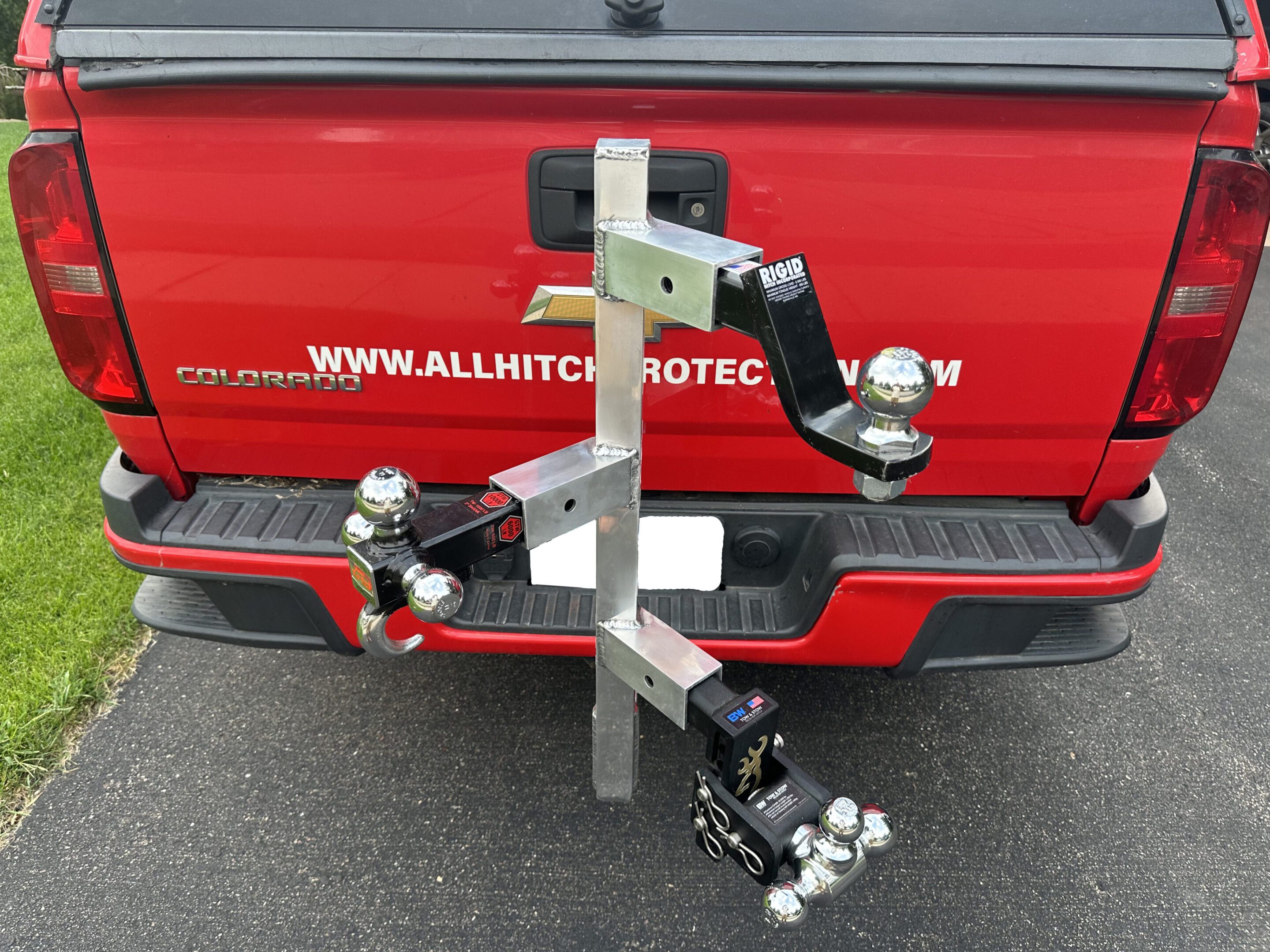 Custom metal hitch-mounted bike rack attached to a vehicle's rear.