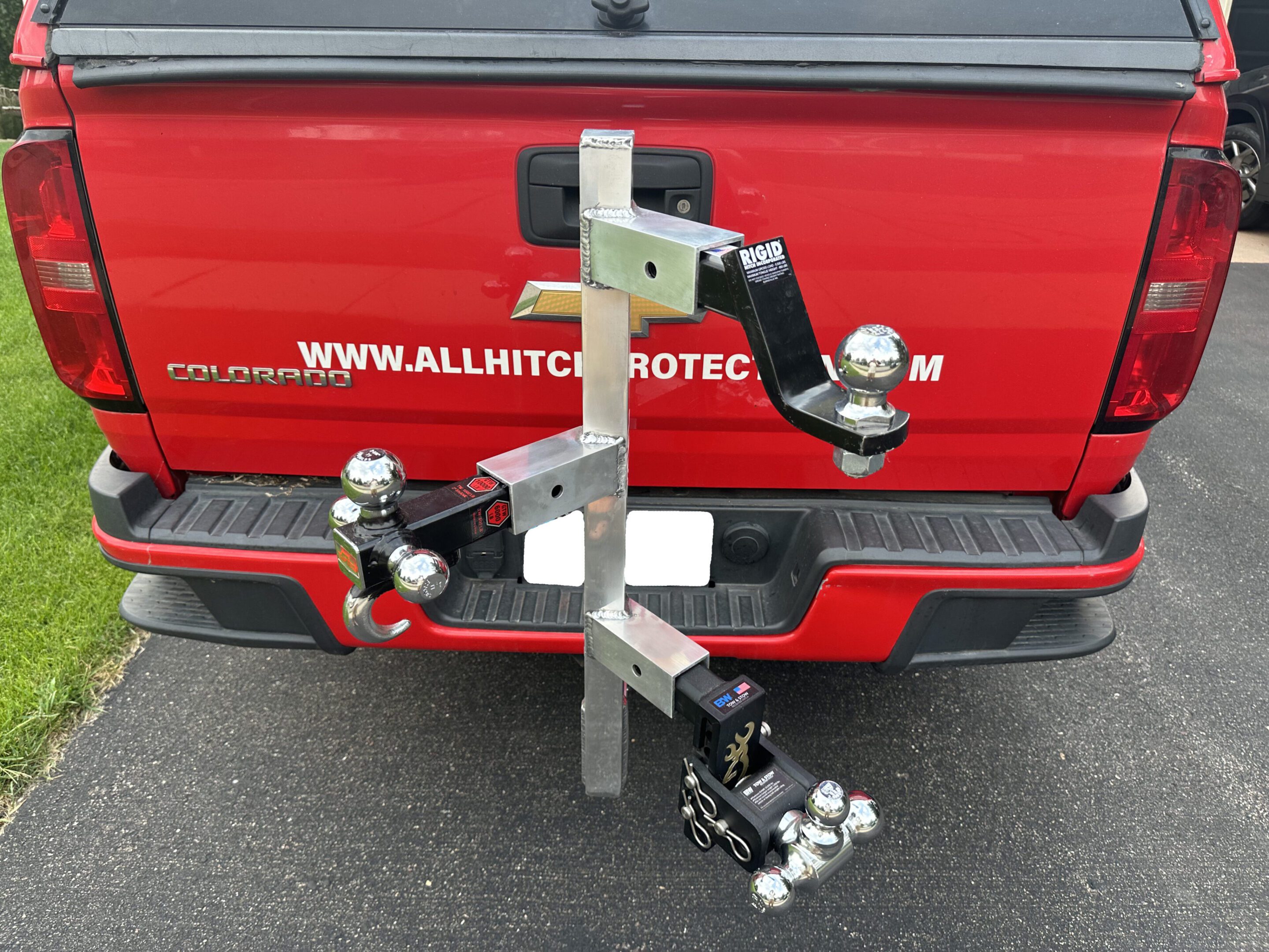 A metal hitch-mounted bike rack attached to a vehicle's trailer hitch.