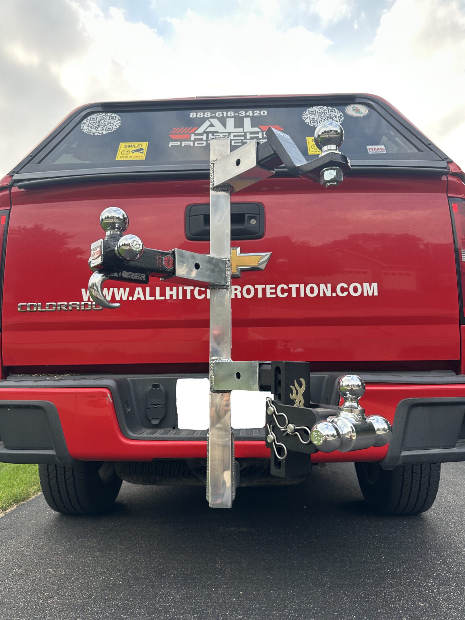 Rear view of a red truck with a custom hitch and tow equipment.