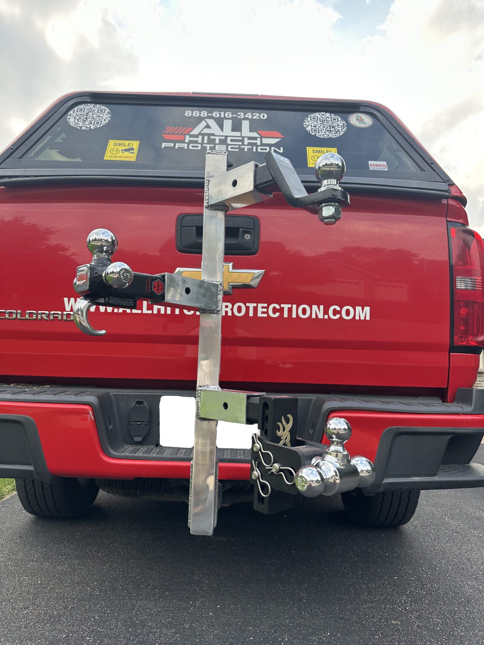 Red SUV with multiple hitch-mounted bike racks attached to its rear.