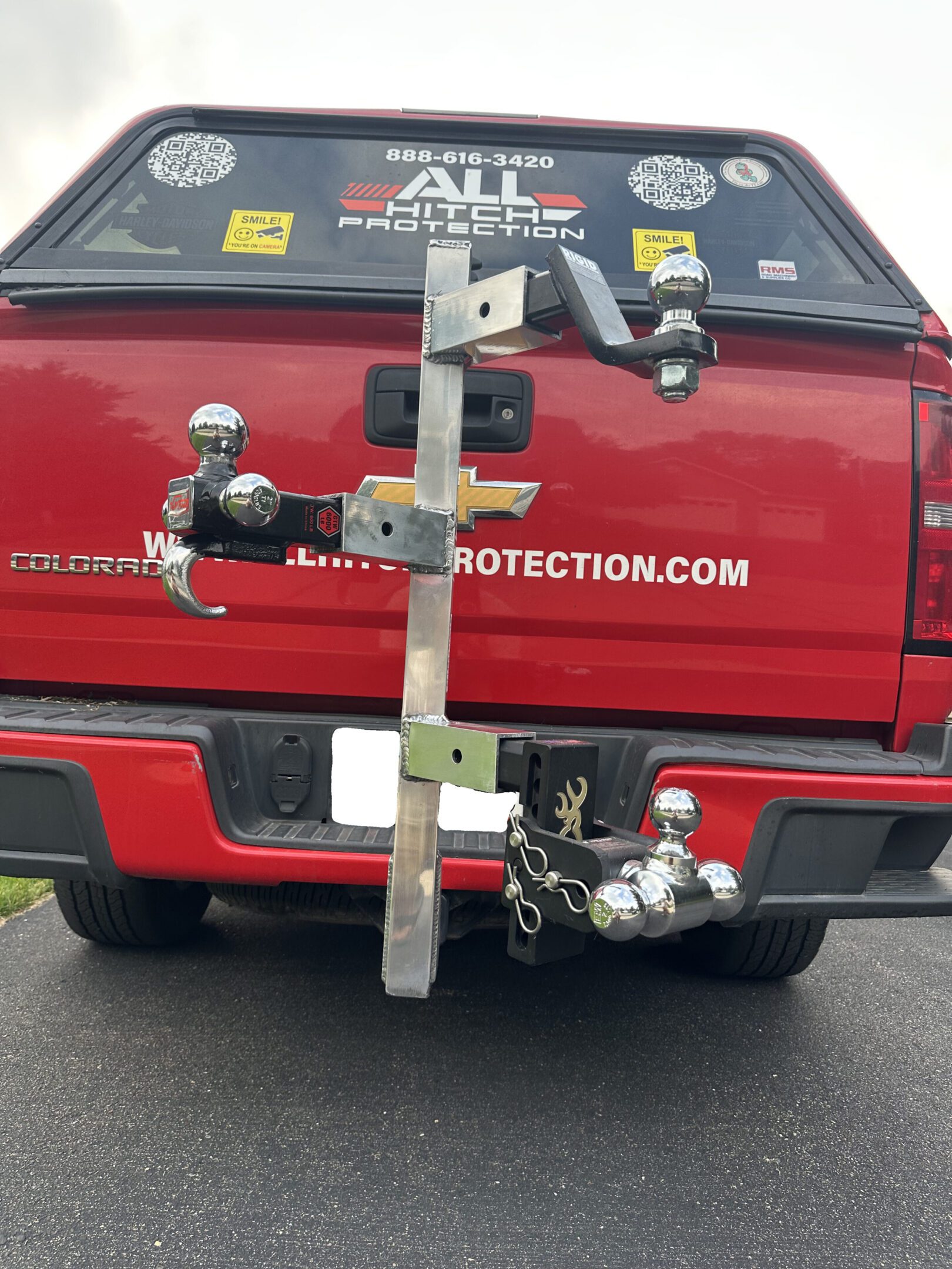 Custom hitch-mounted bike rack attached to a red truck.