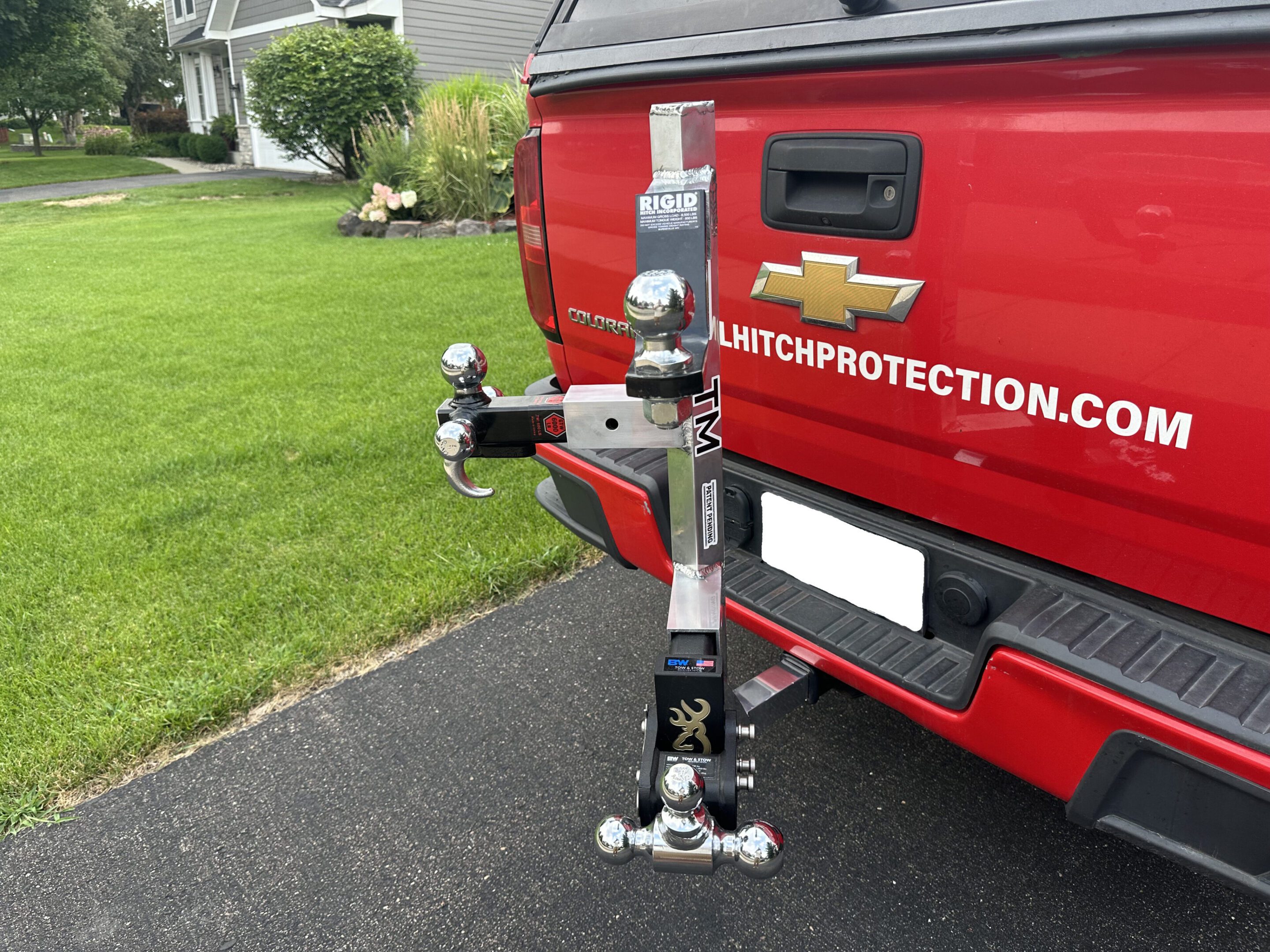 Tow hitch extension mounted to red pickup
