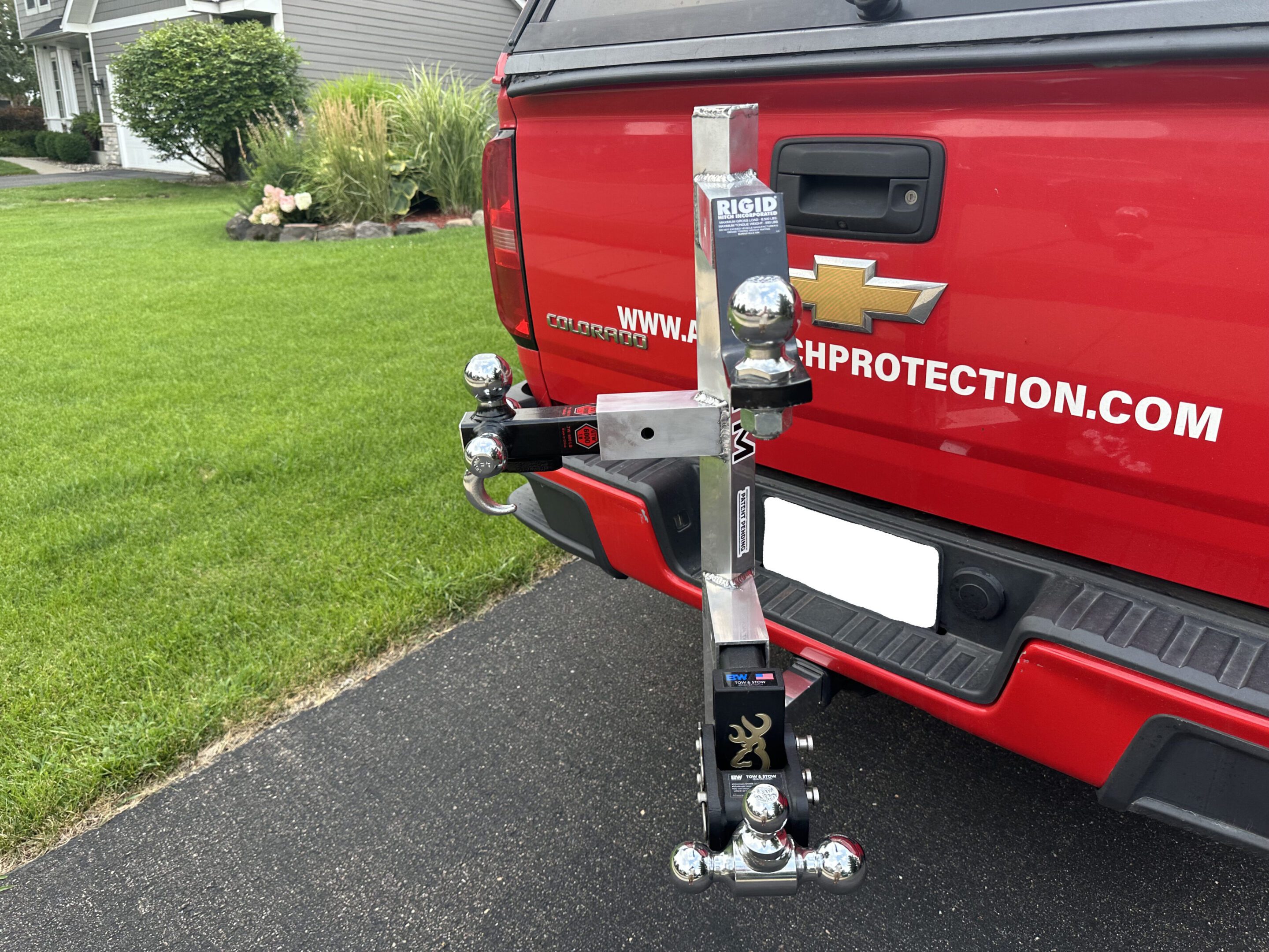 Decorative snowman attached to a vehicle's tow hitch.
