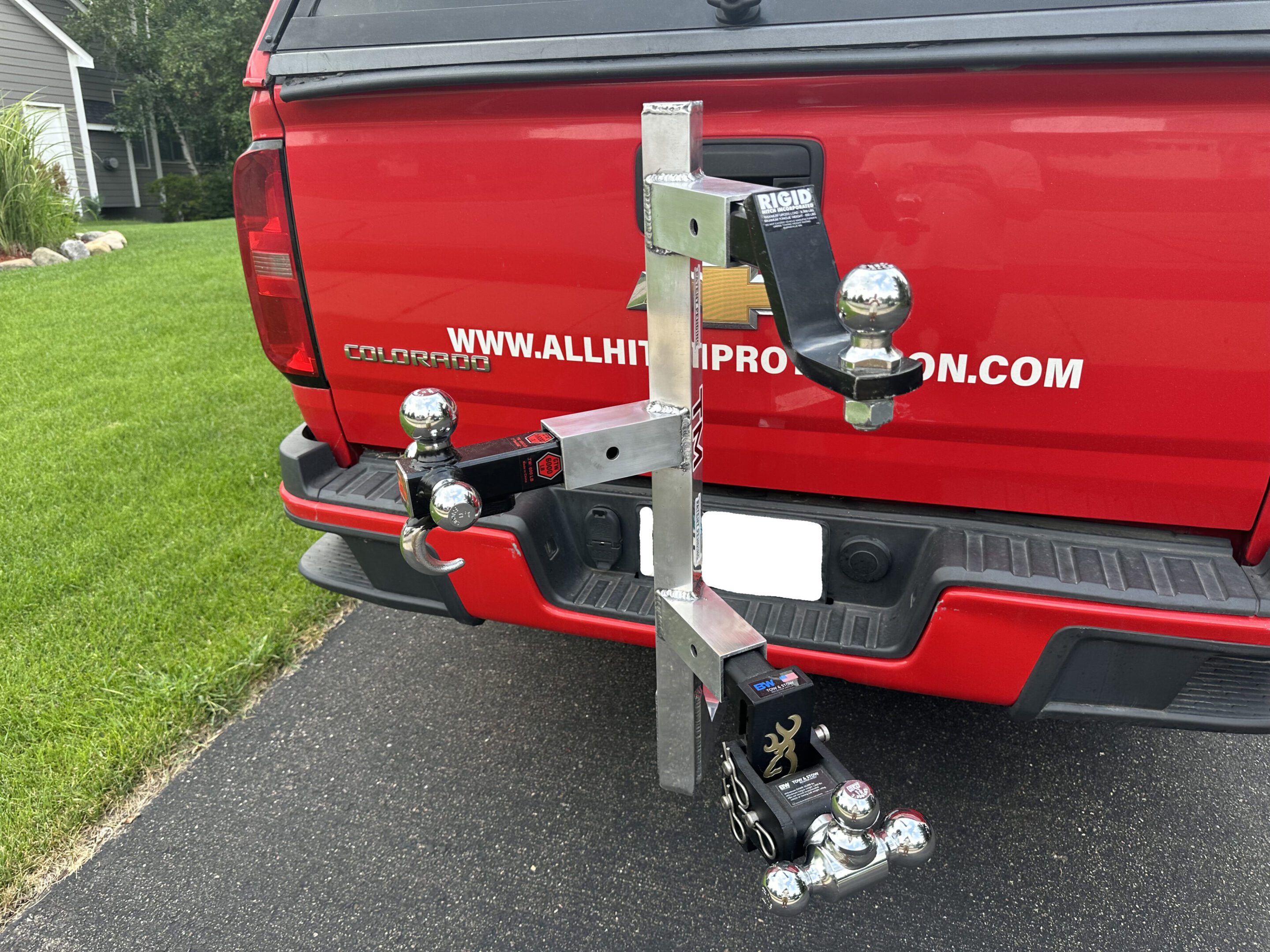 Truck hitch-mounted bike rack with multiple bikes secured.