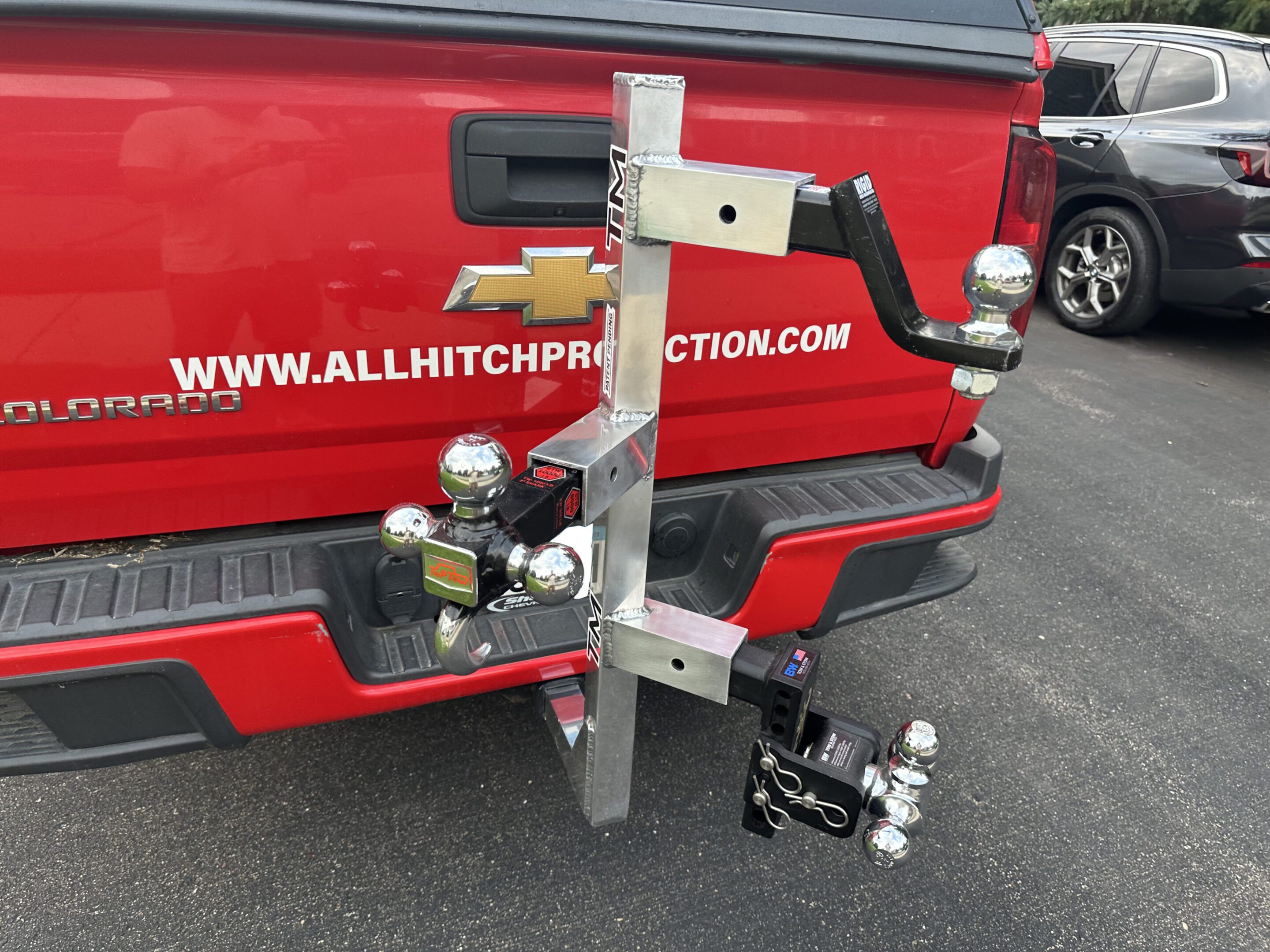 Metal hitch attachment mounted on a vehicle's rear hitch receiver.