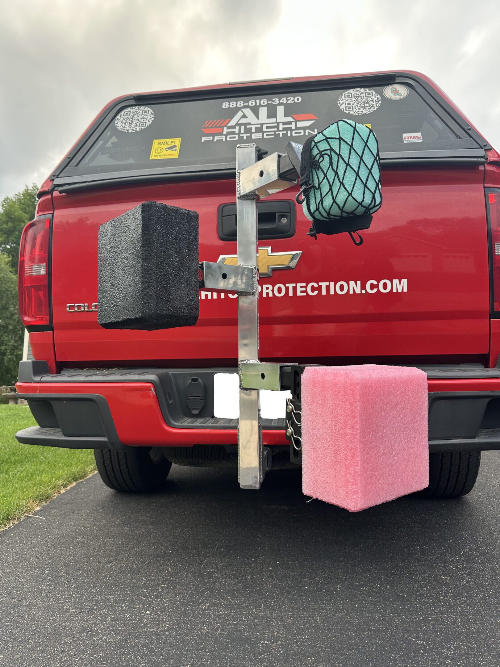 A red vehicle with foam blocks attached to its rear end.