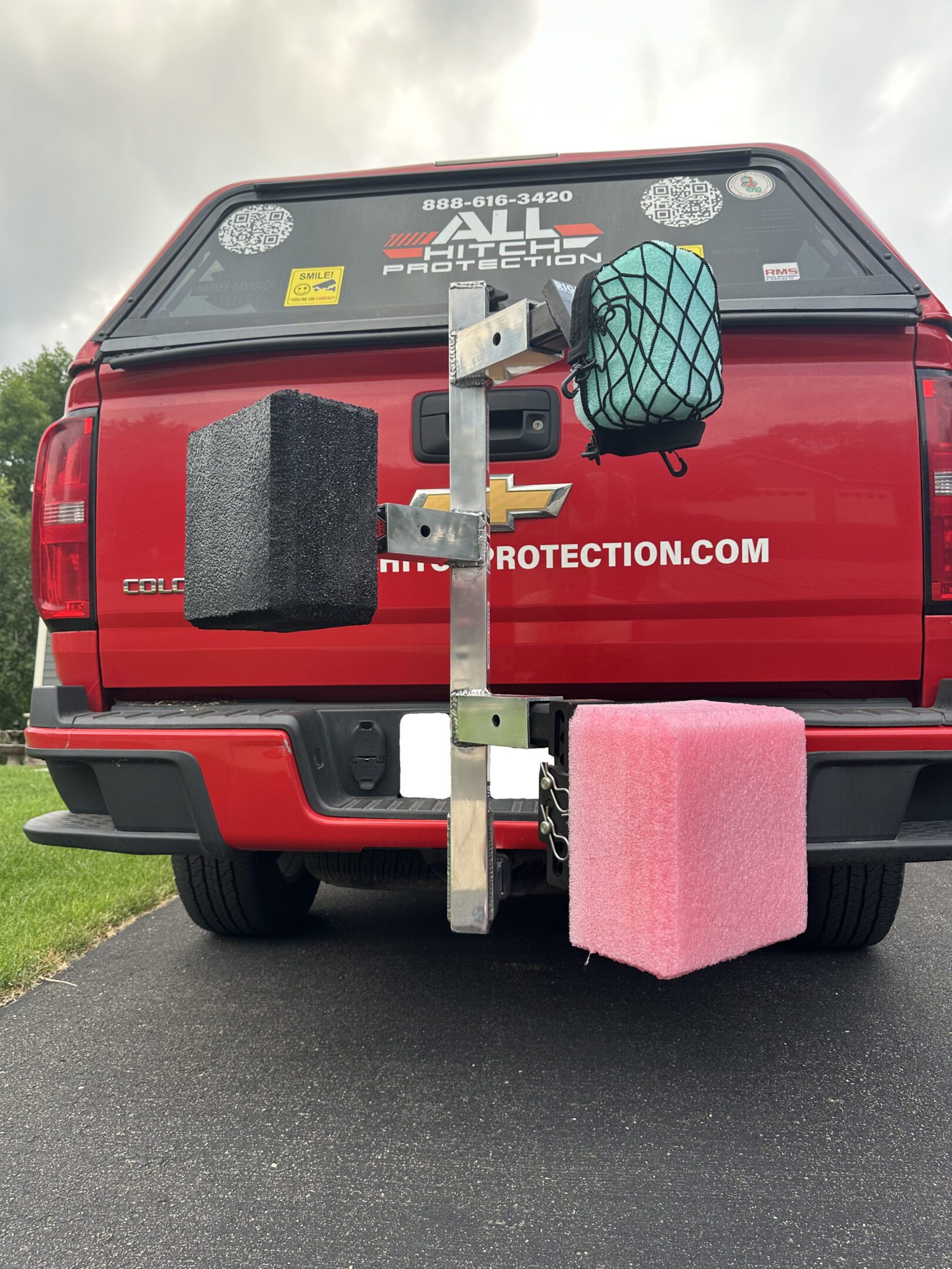 Rear view of a truck with three large foam blocks mounted on its hitch.