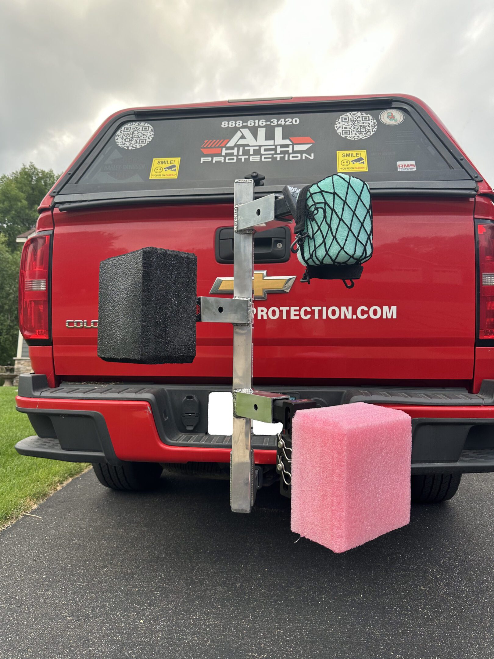 Three differently sized foam blocks mounted on the back of a red truck.
