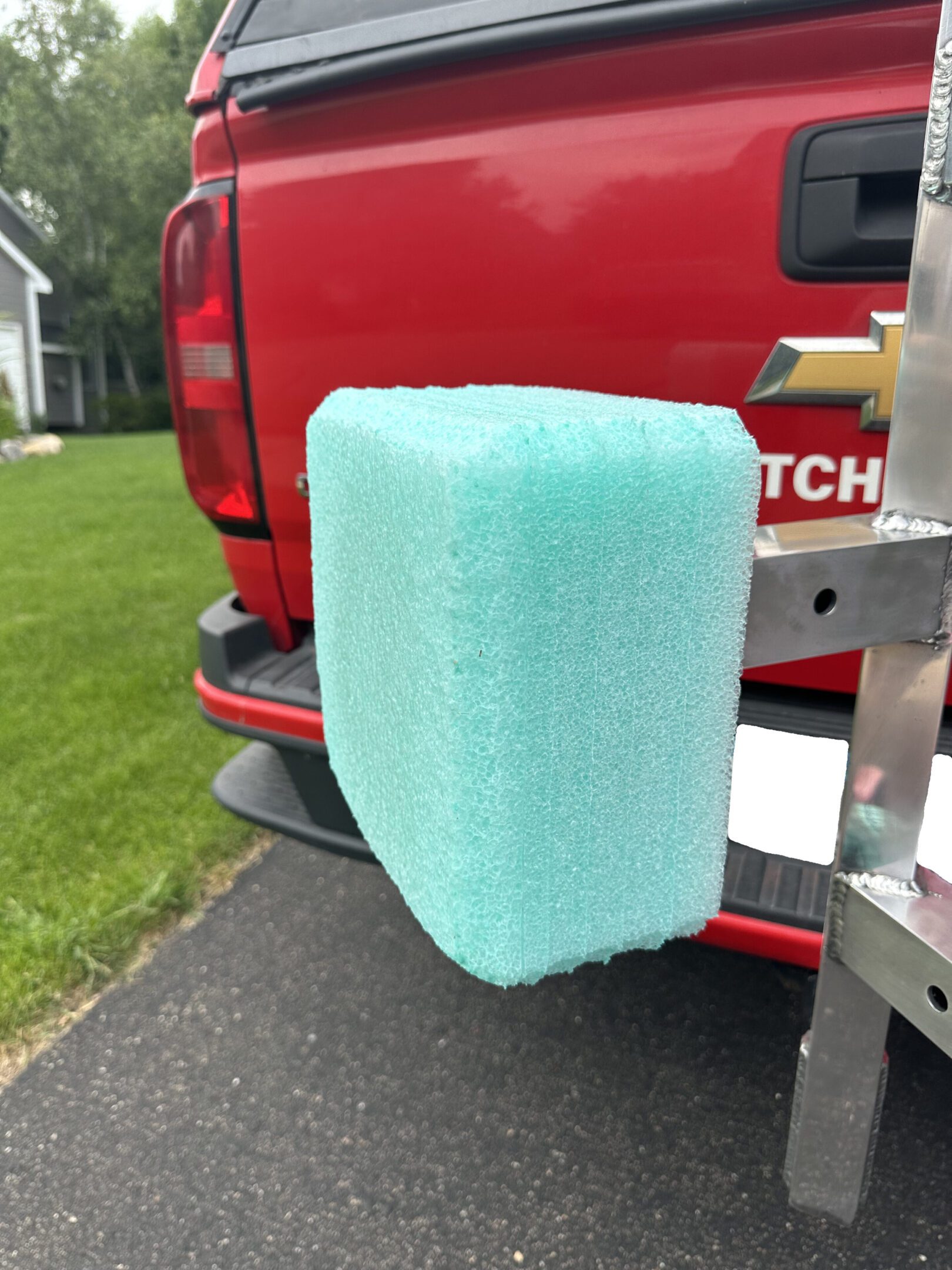Light blue foam block attached to a red vehicle's rear.