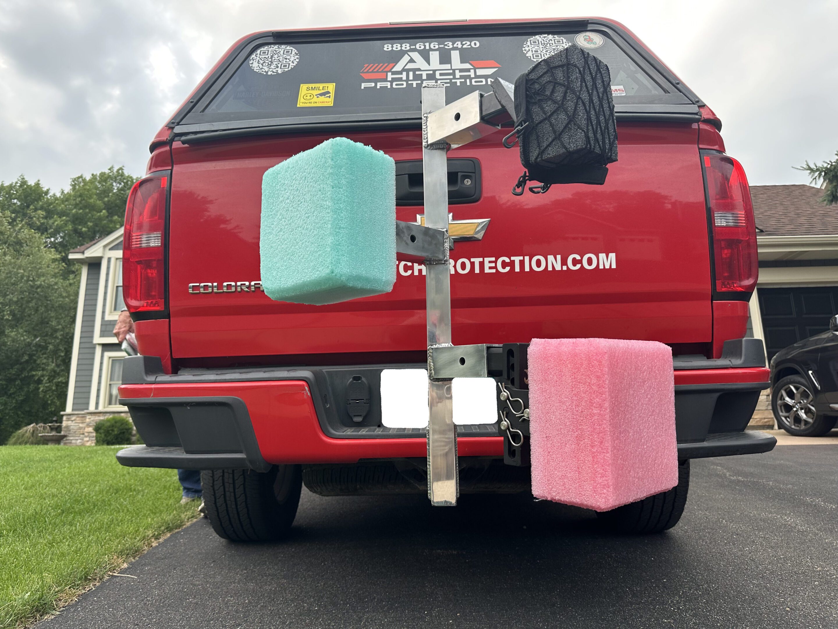 Red truck with colorful foam blocks attached to its rear.