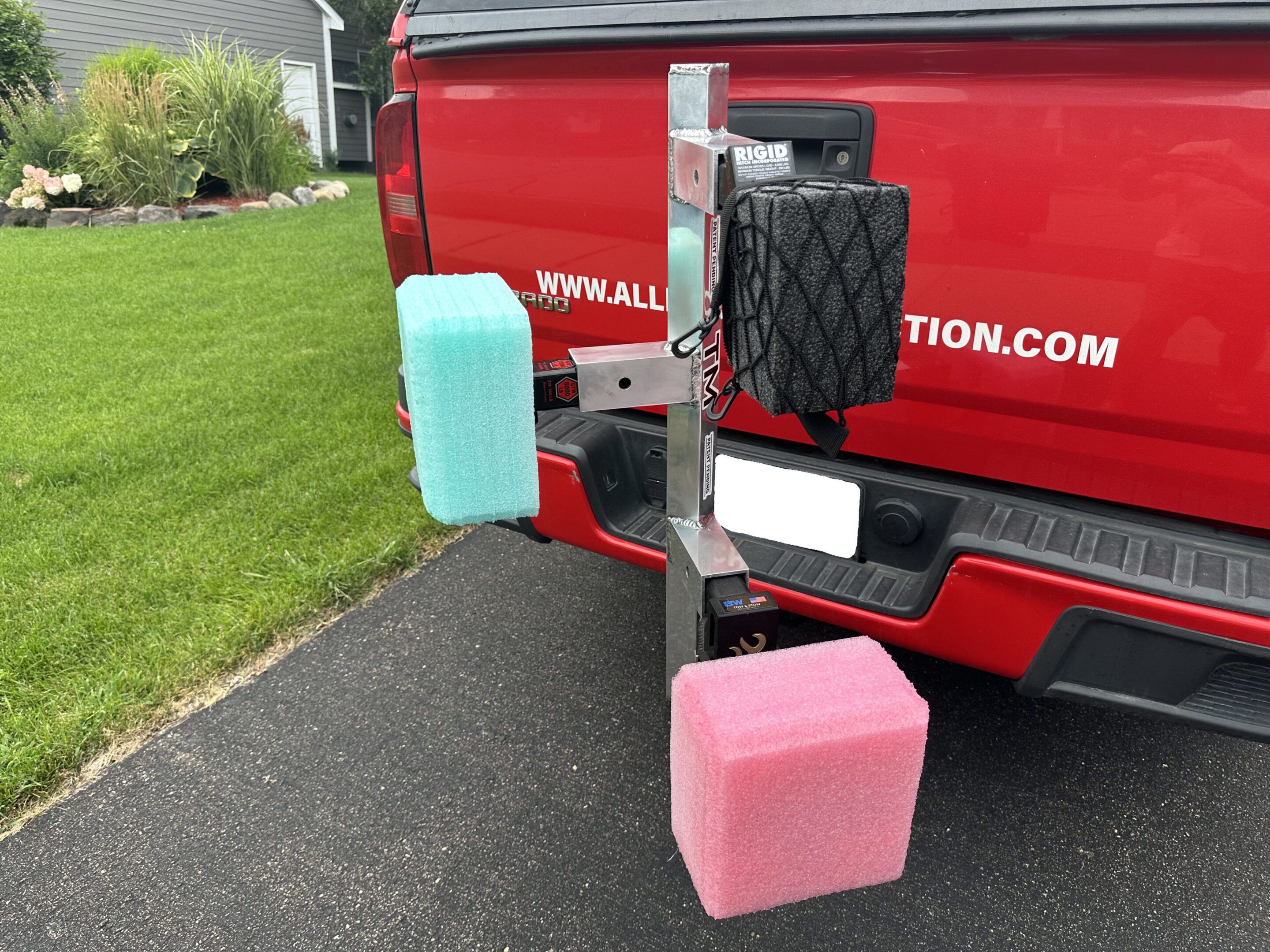 A truck hitch with colorful foam blocks attached at the back.