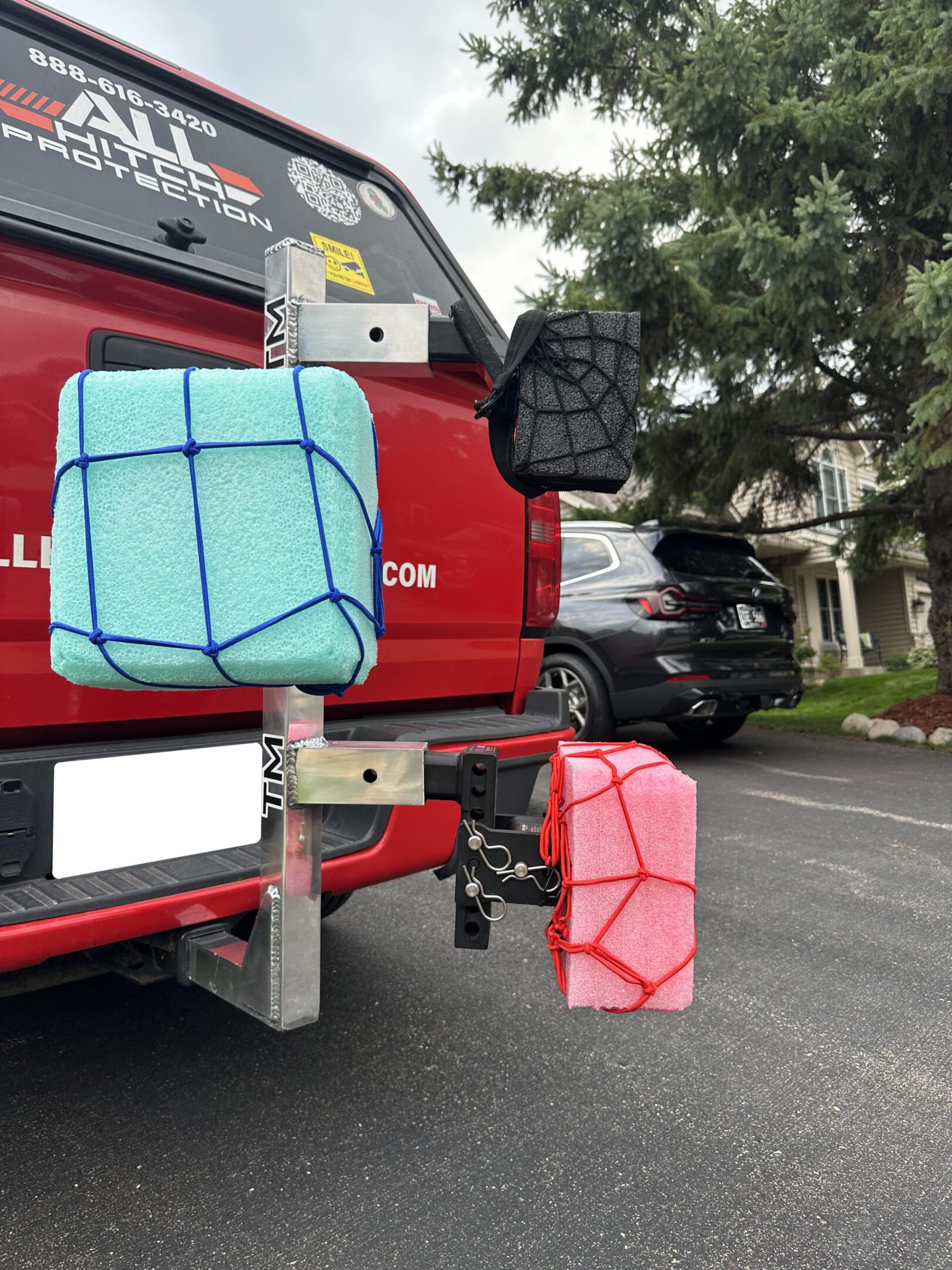 Two colorful homemade splatter guards attached to a vehicle's rear.