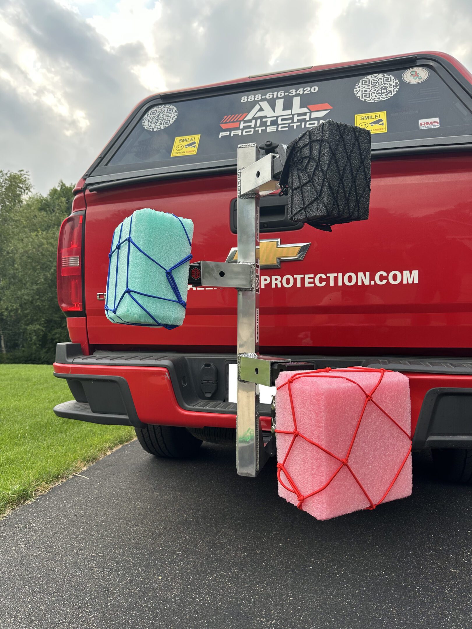 Rear view of a red vehicle with two mounted storage containers.