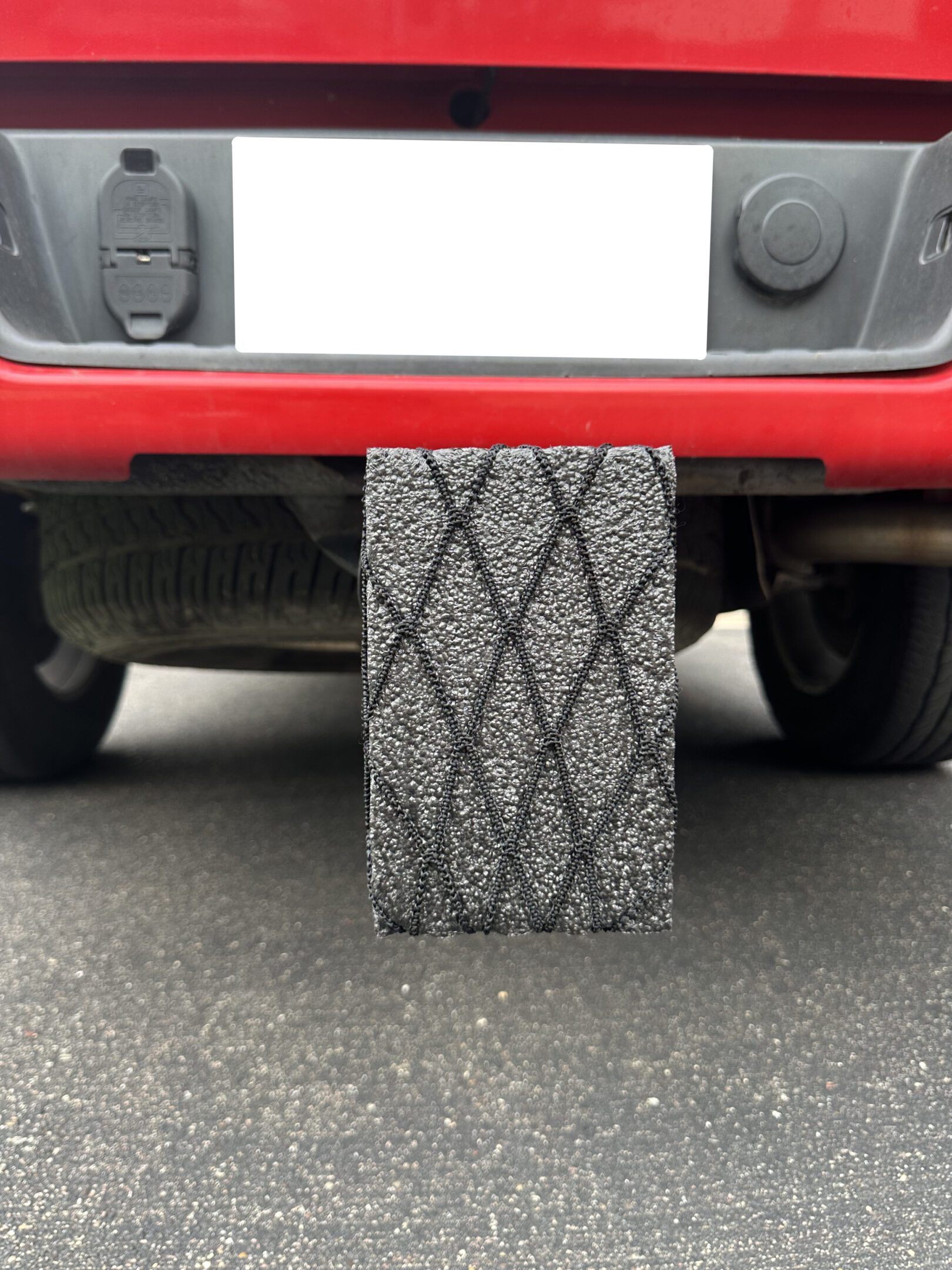 Close-up of a diamond-patterned tire tread on a vehicle.