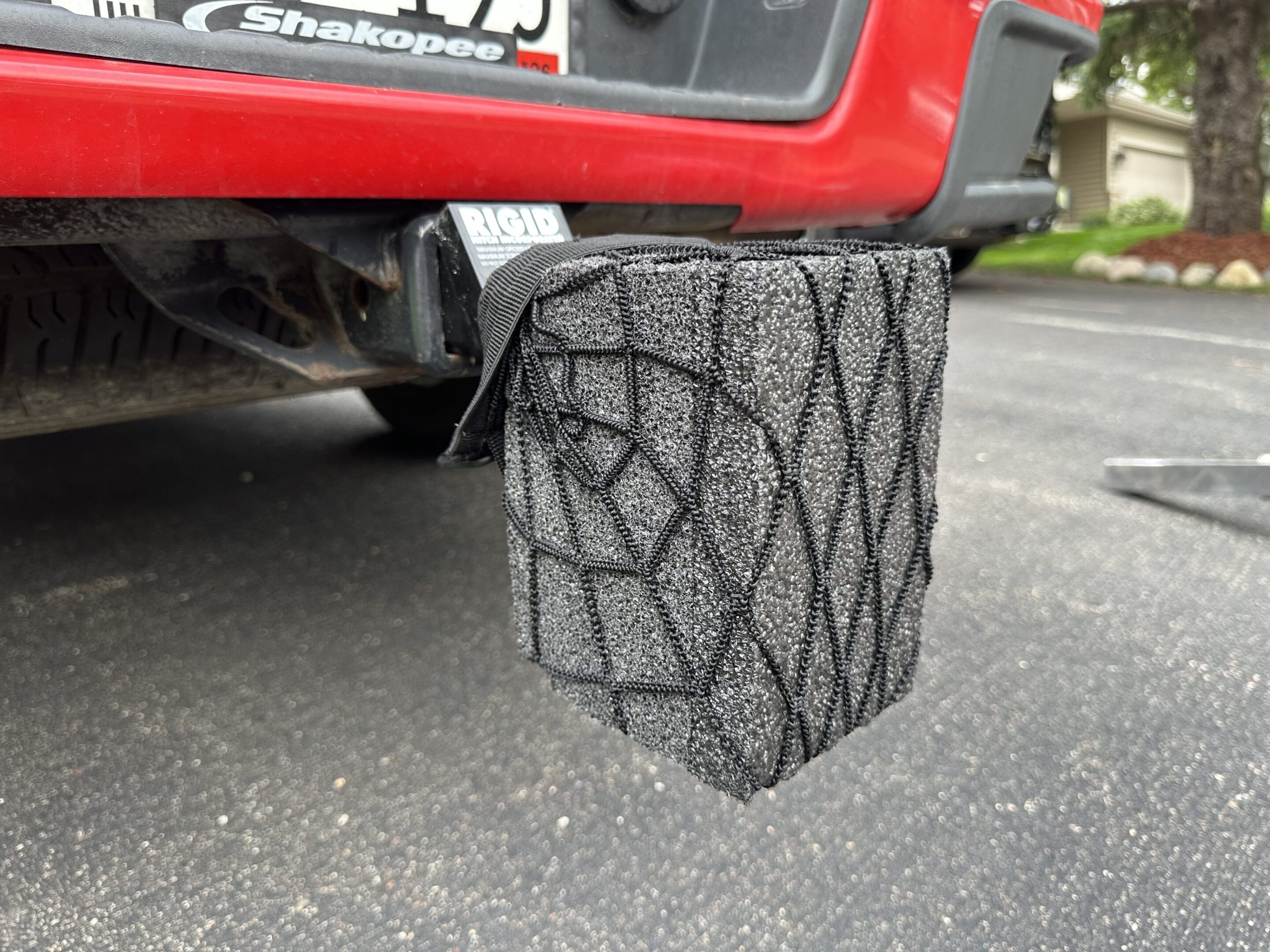 A car exhaust tip designed to look like a spider web.