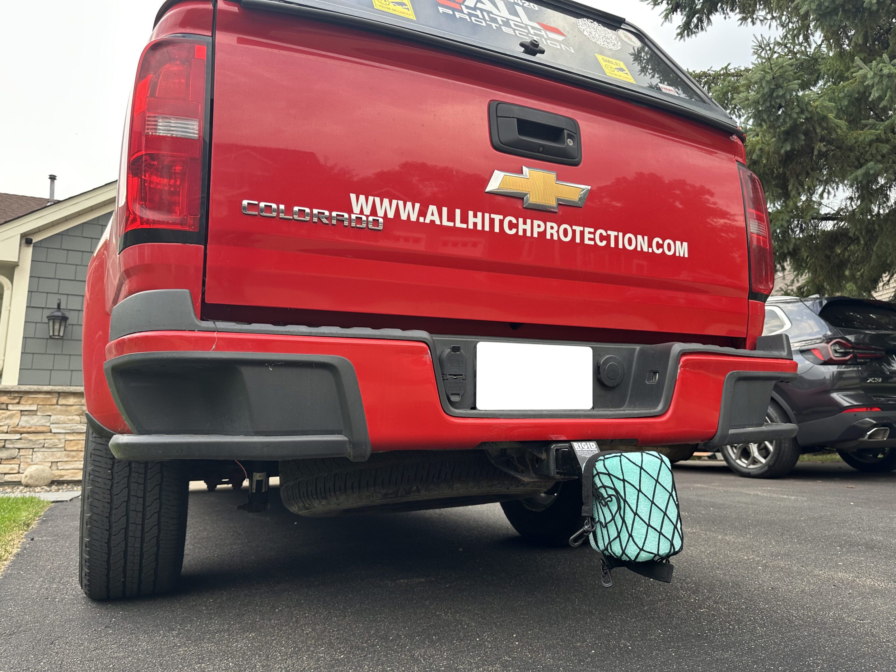 Red Chevrolet truck with a protective cover on the exhaust pipe.