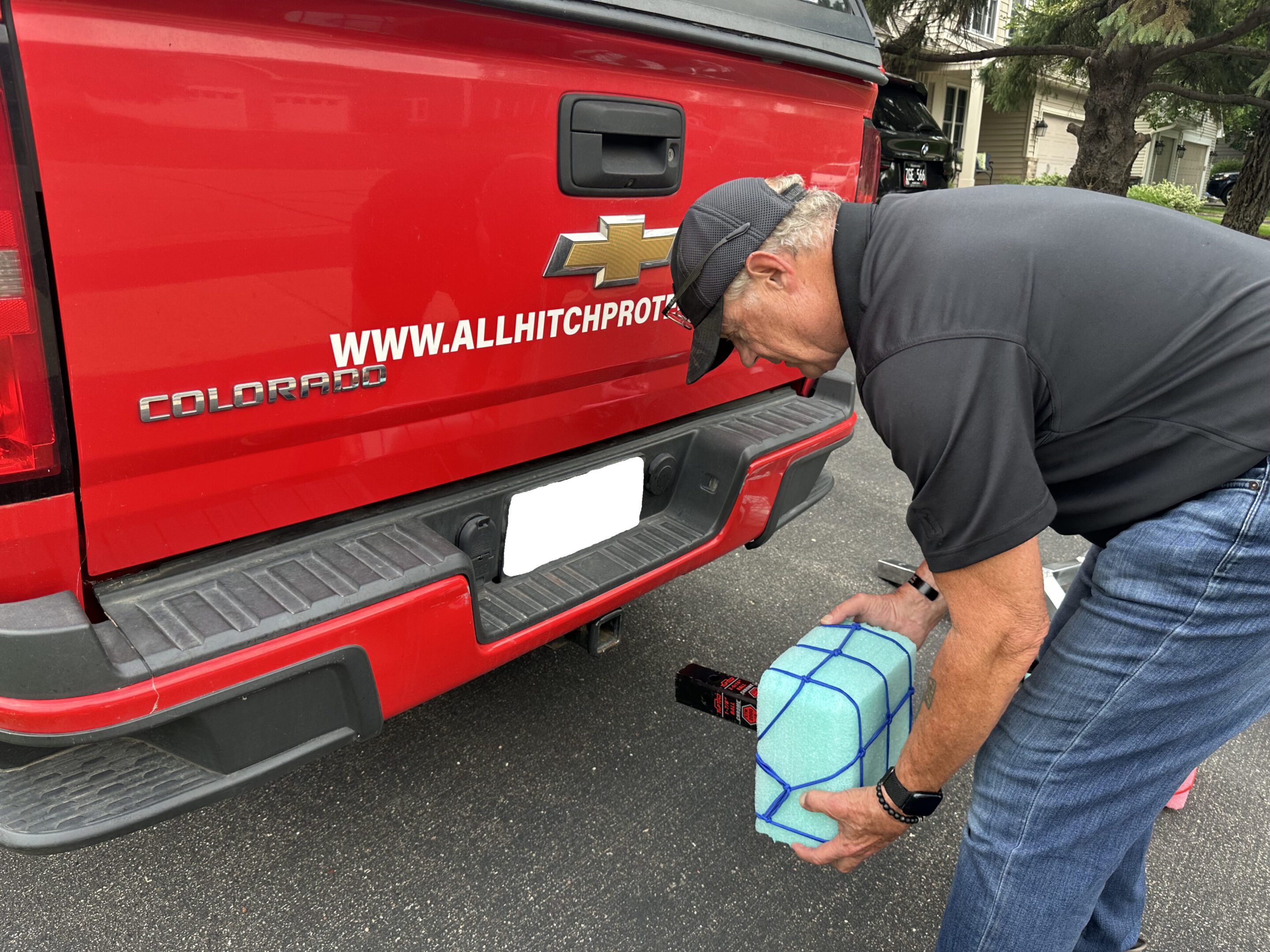 Man refilling a truck's DEF tank at home.