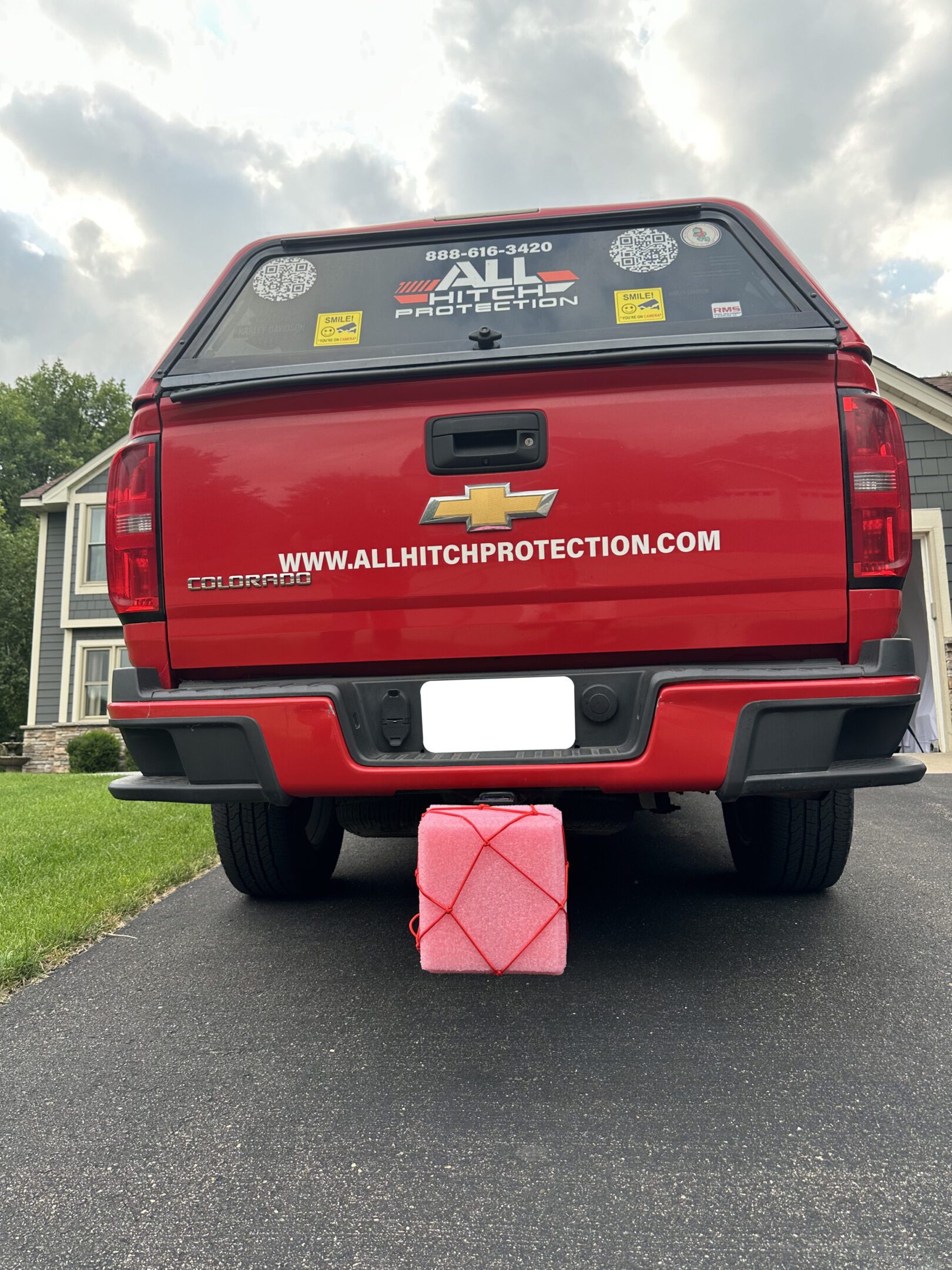 Red pickup truck with a gasoline container beside the rear bumper.