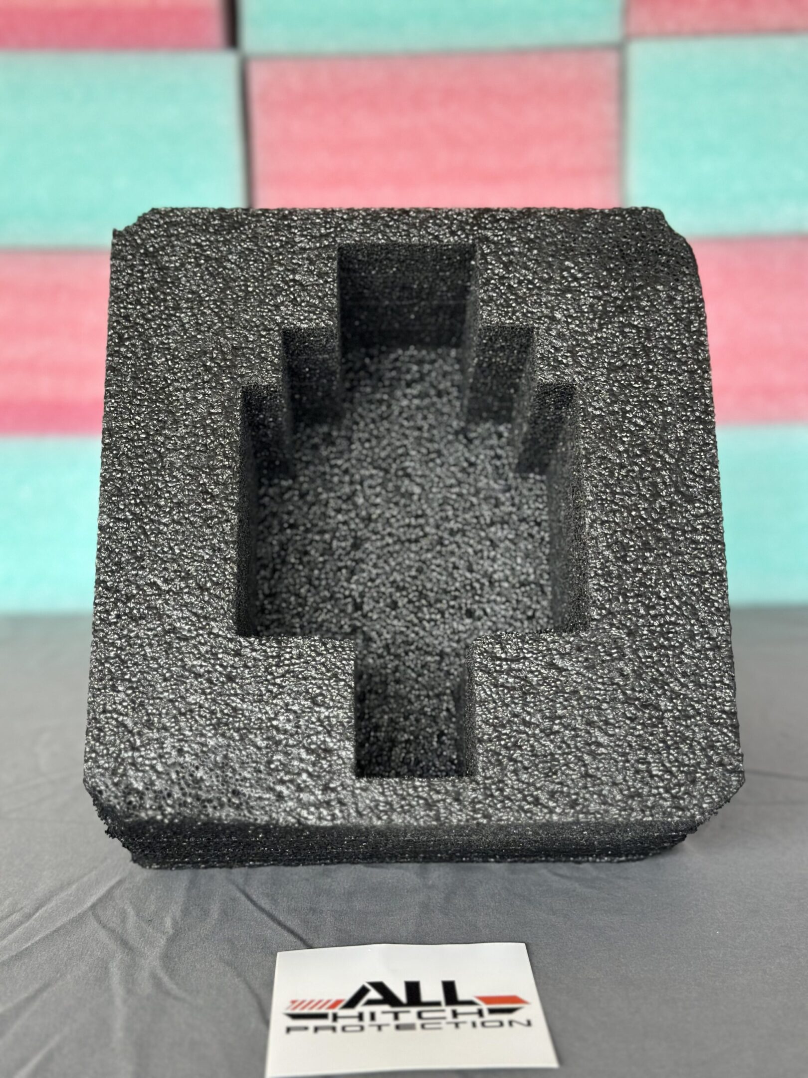 Black foam insert with a pixelated hand-shaped cutout.