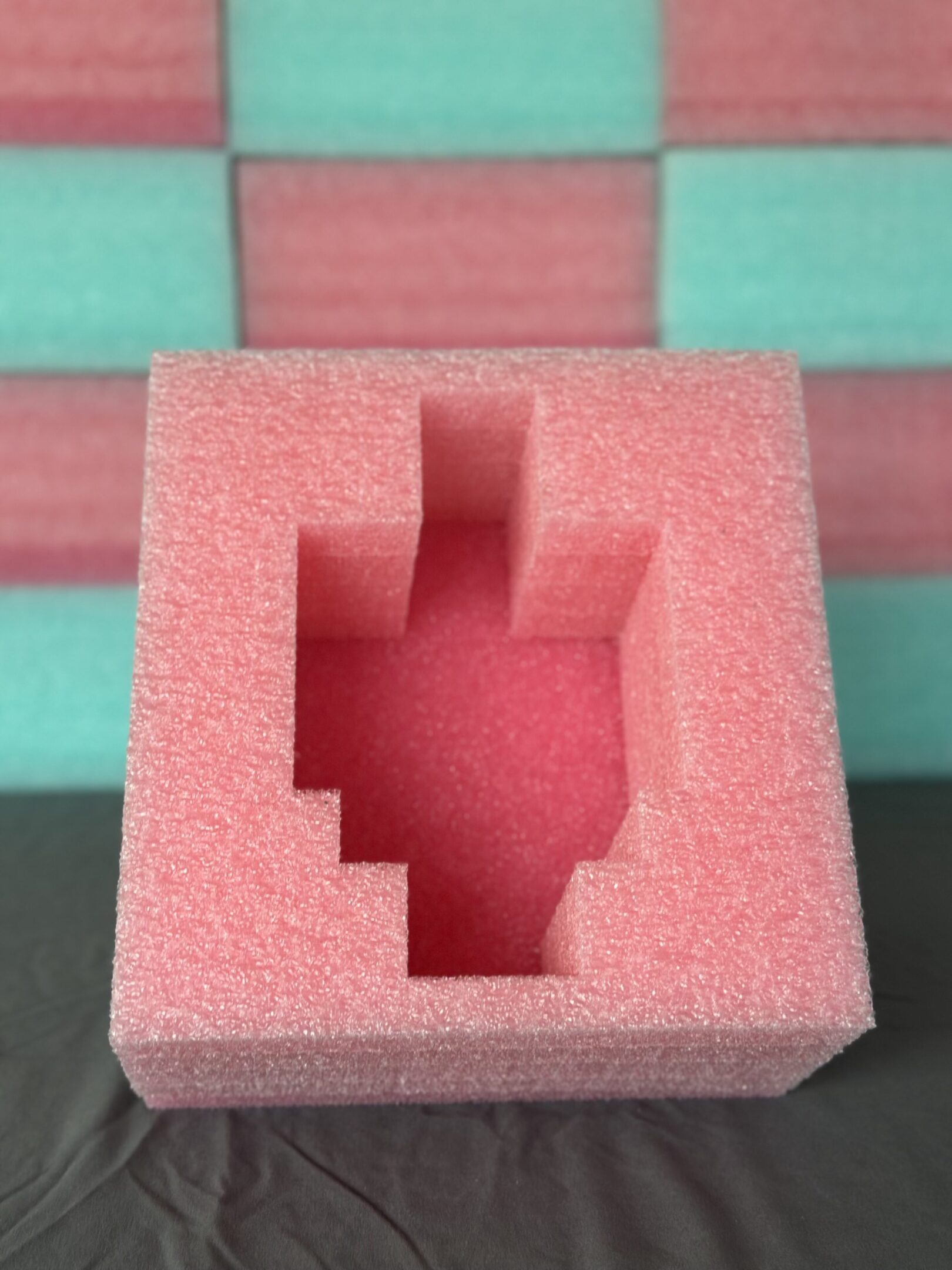 Pink foam with a hand-shaped cutout on a colorful background.