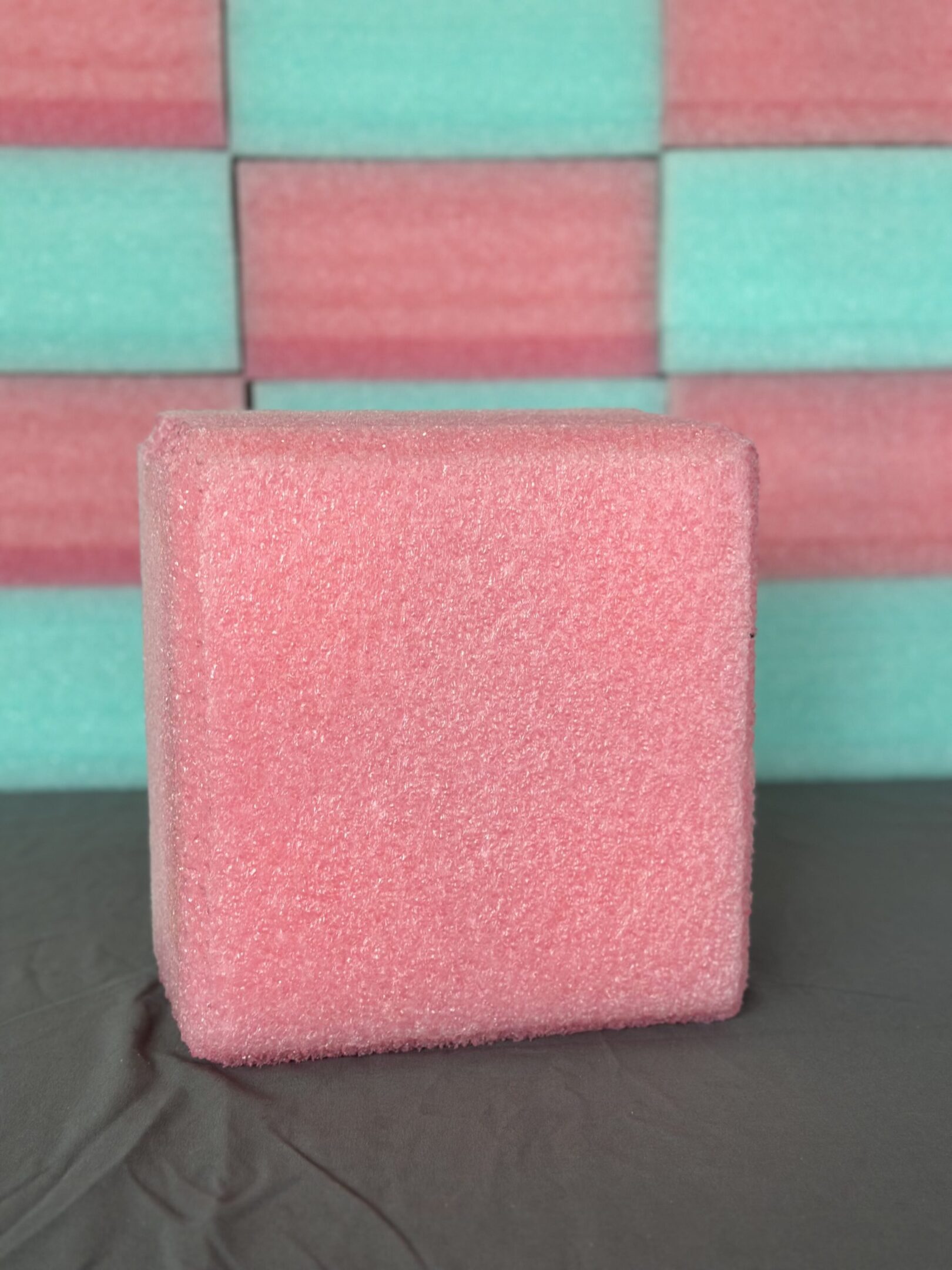 Pink foam sponge block with rectangular shape.