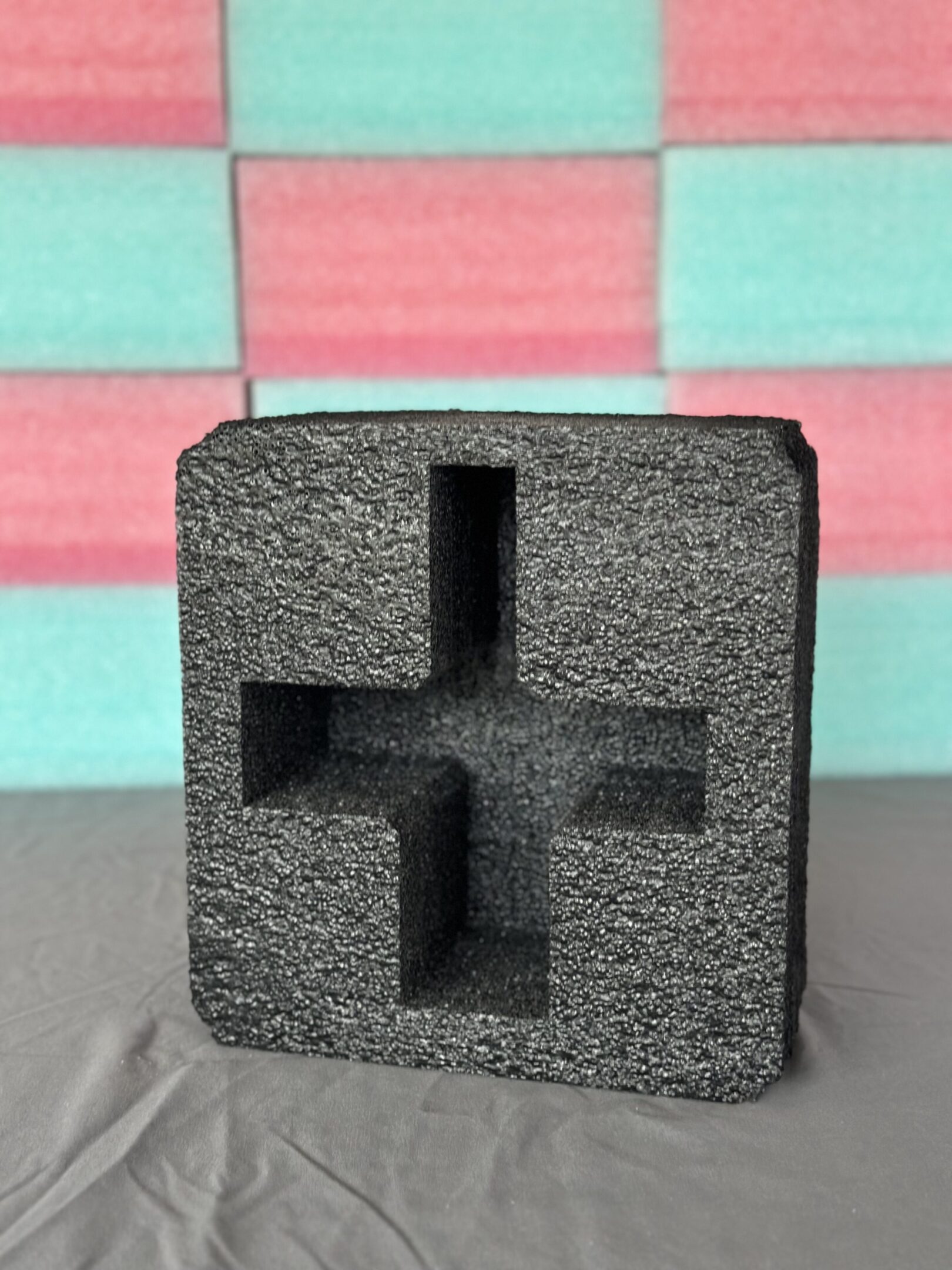 Black foam packaging insert with multiple cutouts for protection.