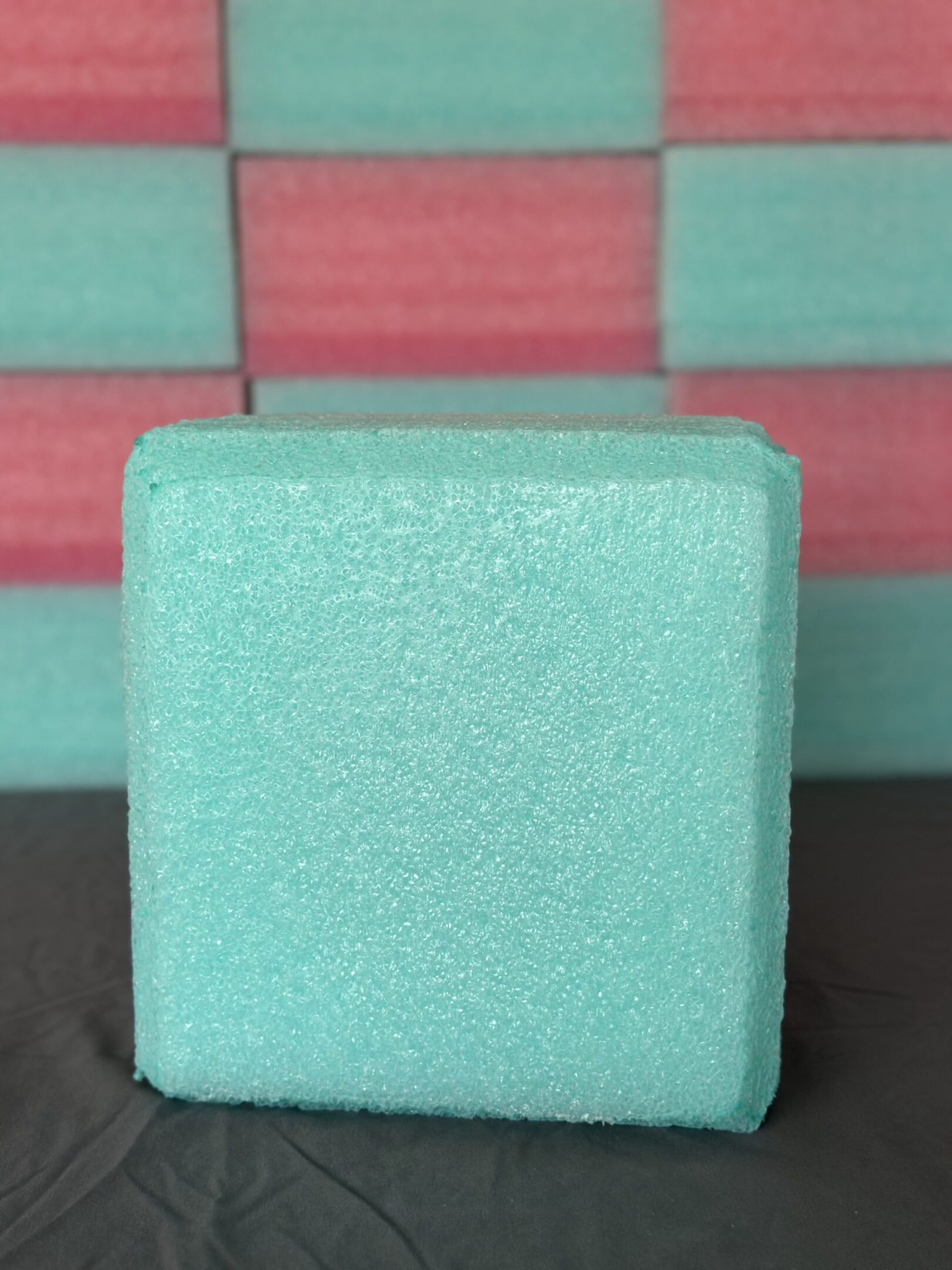 A close-up of a small, light blue textured cube.