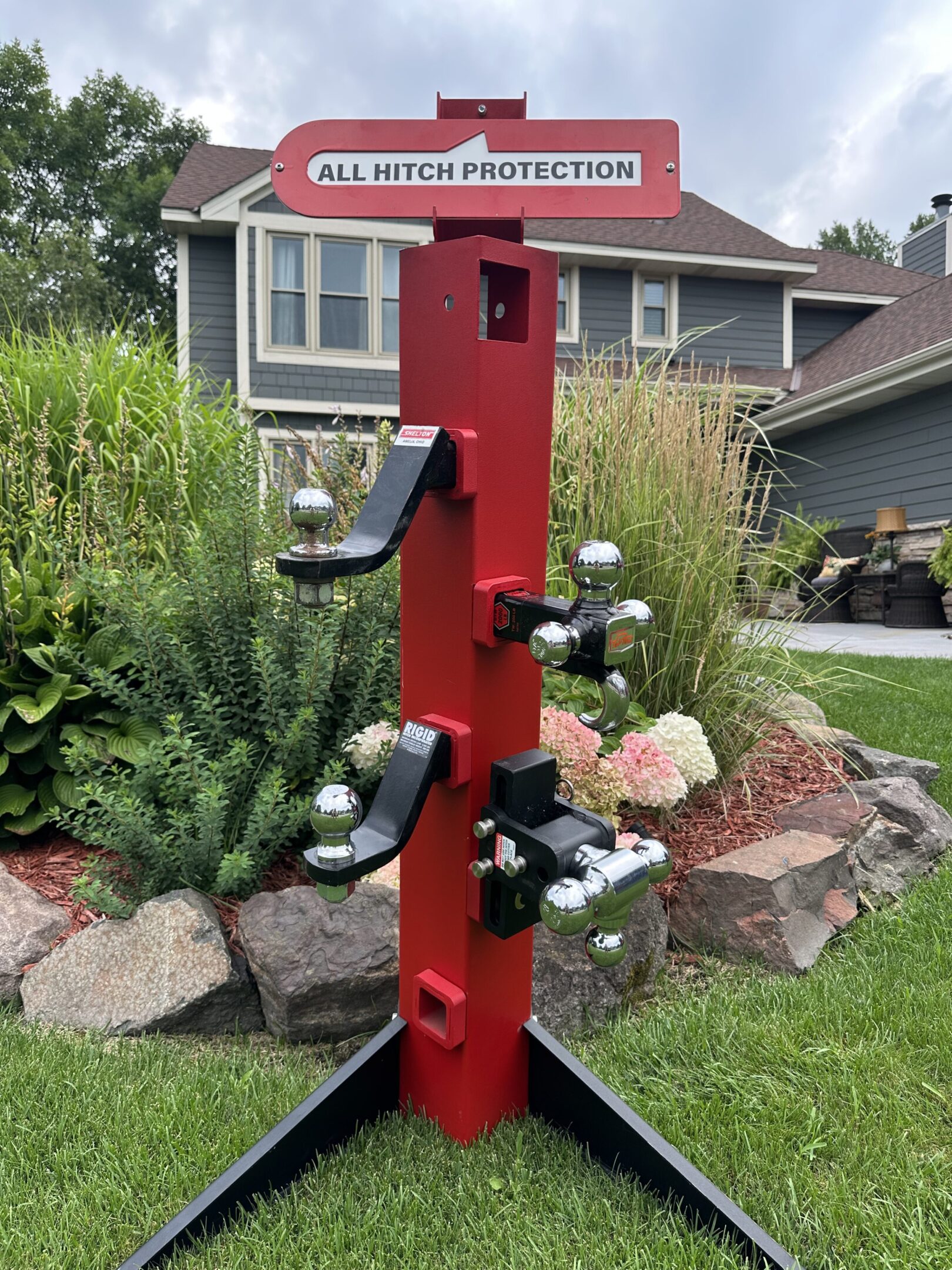 A tall red metal stand with multiple electrical outlets outdoors.