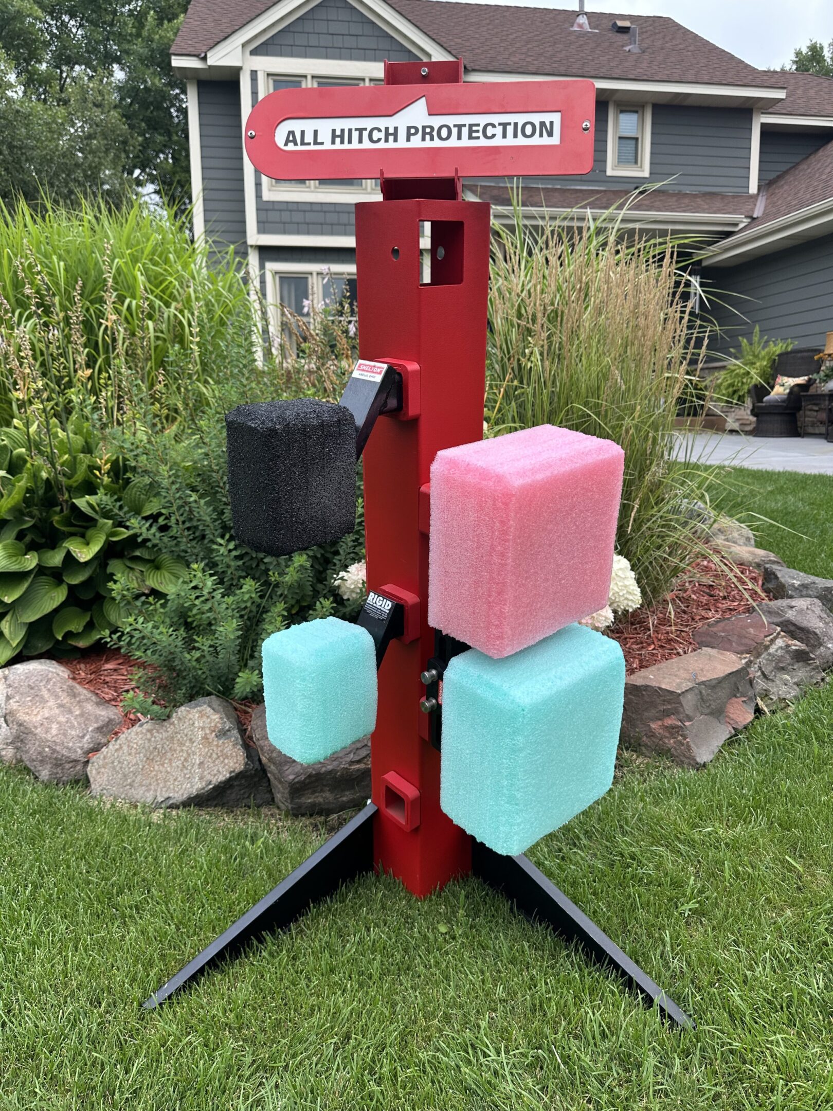 Colorful ice block targets mounted on a red stand outdoors.